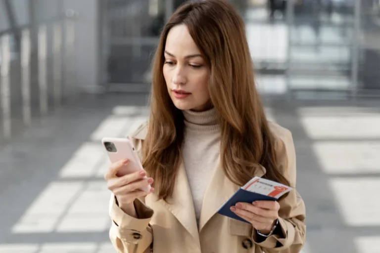 an expat is checking on mobile for paying the overstay fine